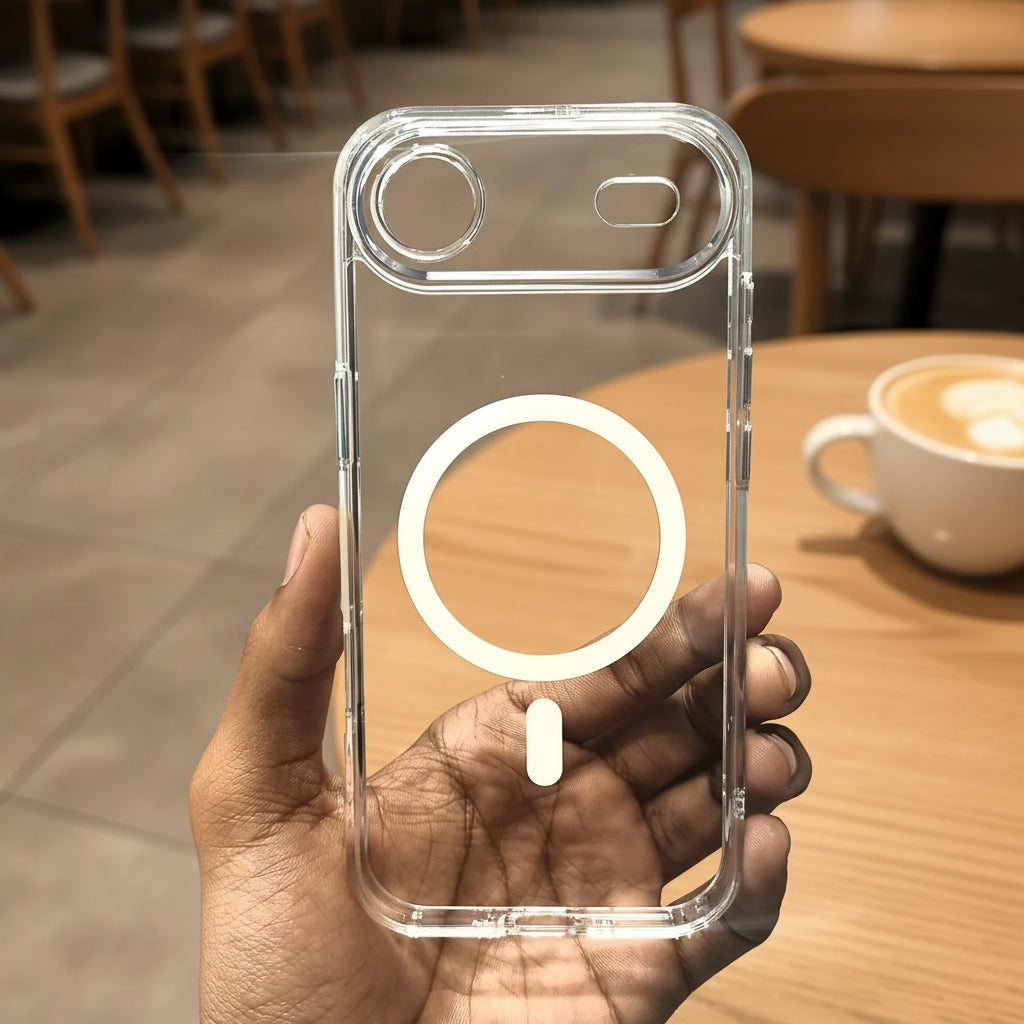 Clear phone case with a magnetic ring holder held by a hand against a neutral background