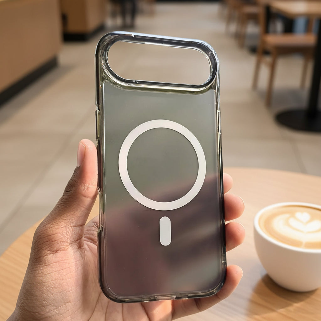 Phone case with a magnifying glass design held in a hand against a blurred natural background