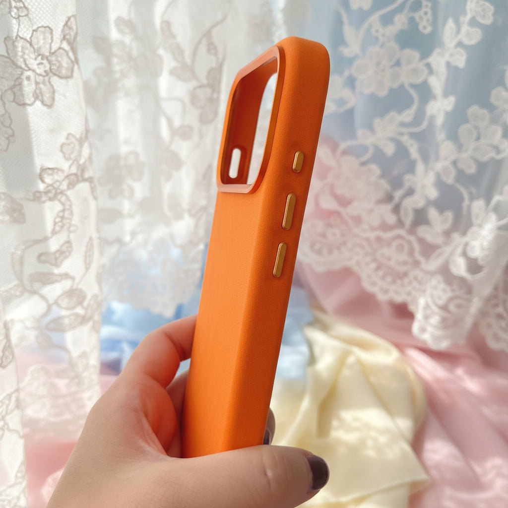 Orange phone case held in a hand with a blurred store background