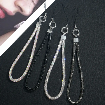 Four phone straps with tassels on a black background