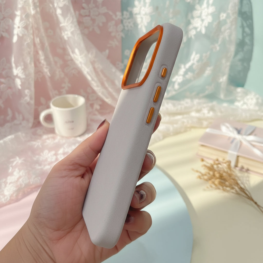 Gray phone case with orange accents held in a hand against a blurred indoor background