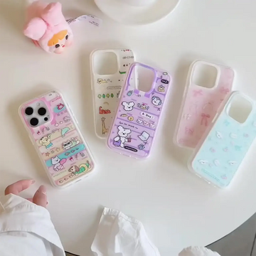 Set of colorful phone cases with cartoon designs on a white surface.