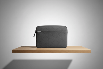 one laptop bags & sleeves at light gray radial background aesthetic view on store display desk