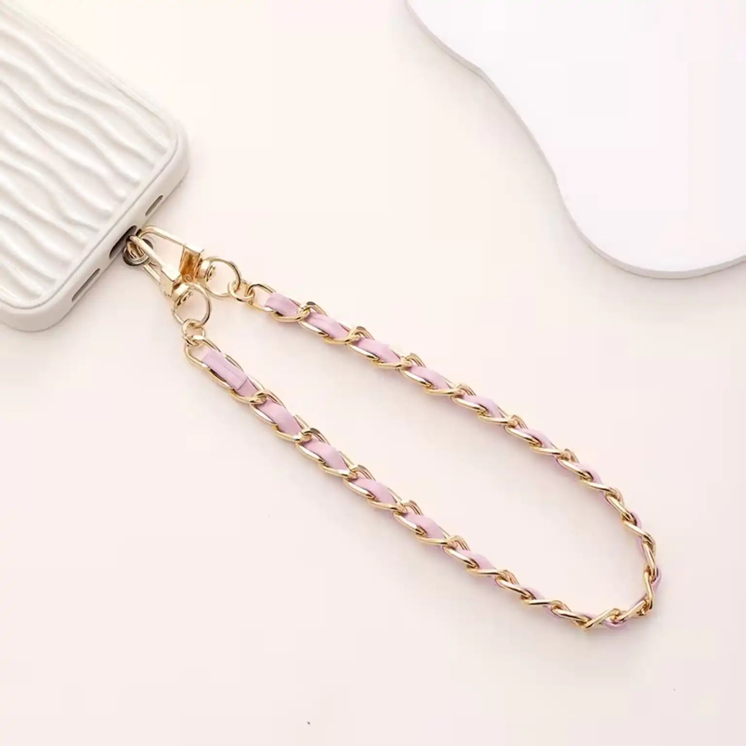 Gold and pink chain on a white background