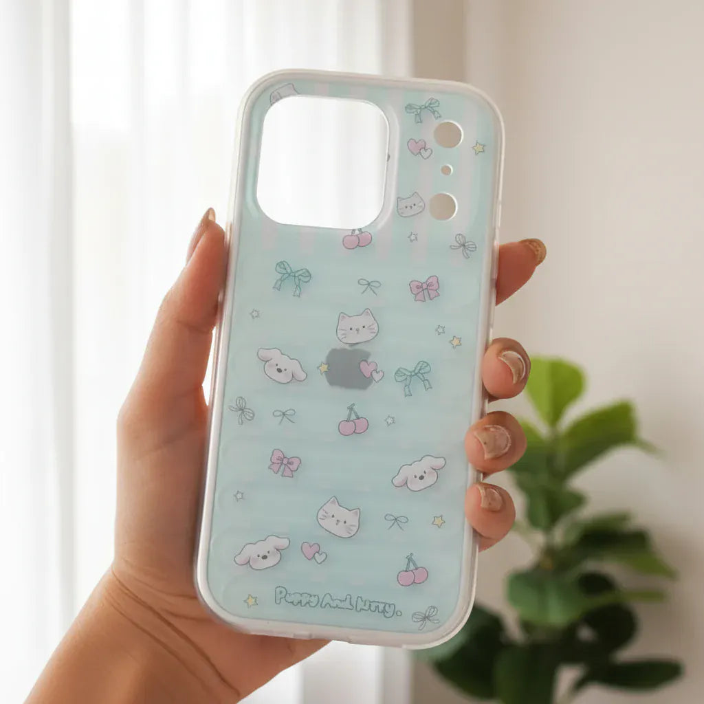 Phone case with cute pattern held by a hand against a blurred green outdoor background