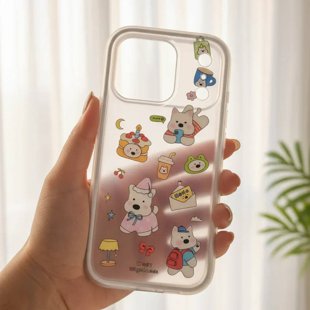 Phone case with cartoon designs held by a hand outdoors