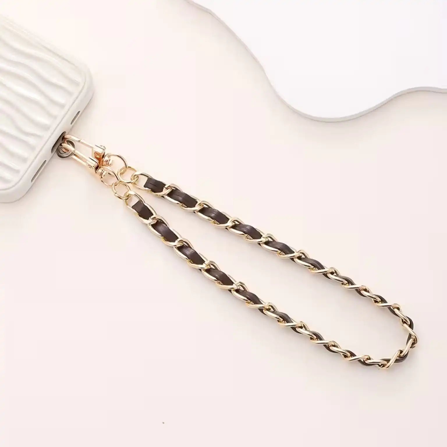 Gold chain strap on a white background
